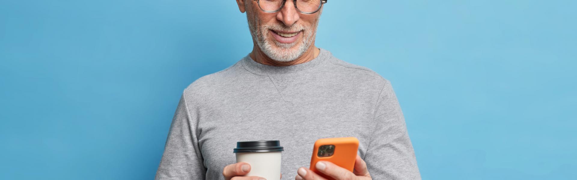 Man with coffee on phone